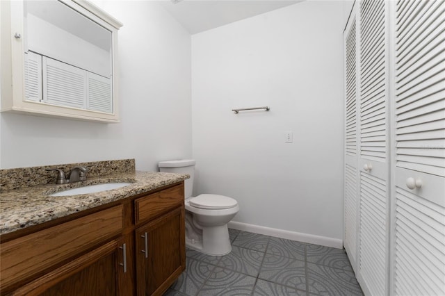 bathroom featuring toilet, tile patterned floors, and vanity