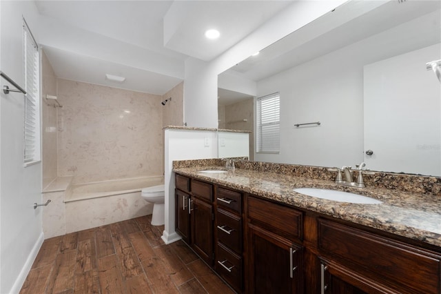 full bathroom with toilet, vanity, and tiled shower / bath combo