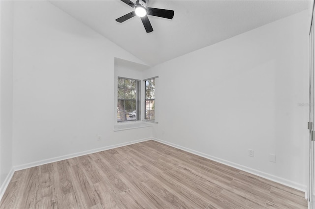 empty room featuring ceiling fan, light wood-type flooring, and vaulted ceiling