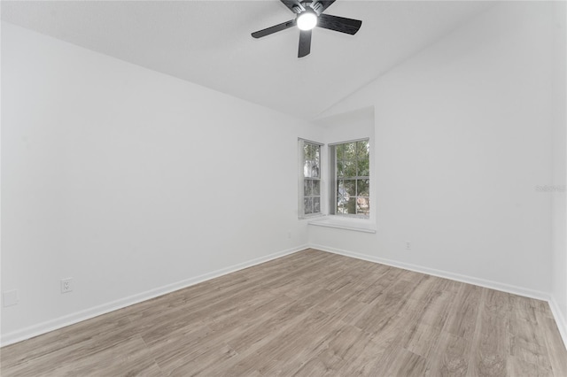 unfurnished room with vaulted ceiling, ceiling fan, and light hardwood / wood-style flooring