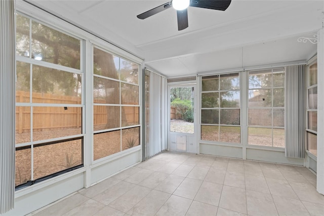 unfurnished sunroom with ceiling fan