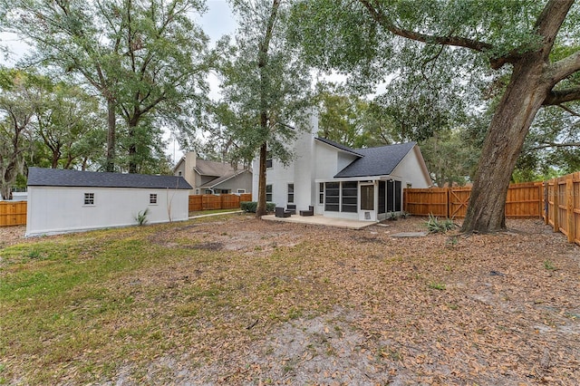 back of house with a patio area and a sunroom