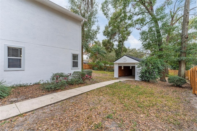 view of yard with a garage and an outdoor structure