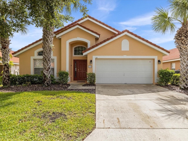 view of front of house featuring a front lawn and a garage