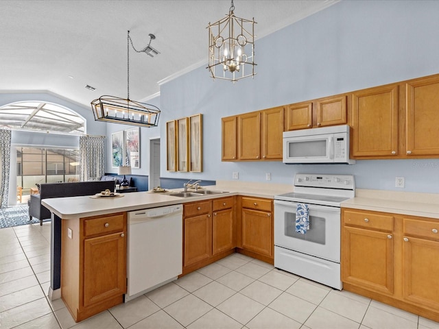 kitchen with decorative light fixtures, a notable chandelier, sink, and white appliances