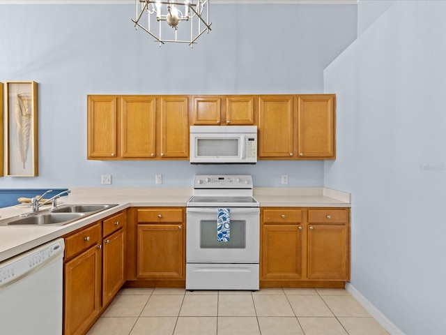 kitchen featuring an inviting chandelier, sink, white appliances, and light tile patterned flooring