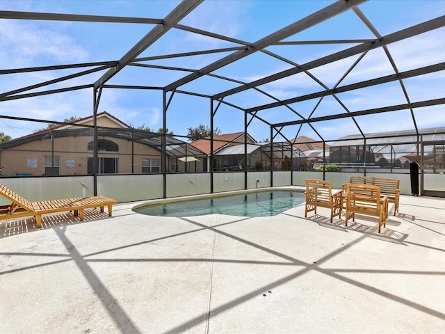 view of swimming pool featuring a lanai and a patio