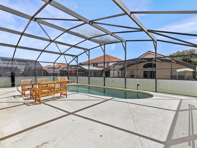 view of pool featuring a patio area and glass enclosure