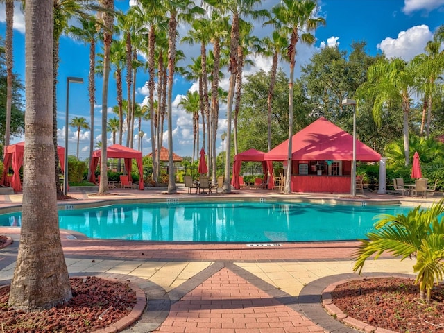 view of pool featuring a gazebo, an outdoor structure, and a patio