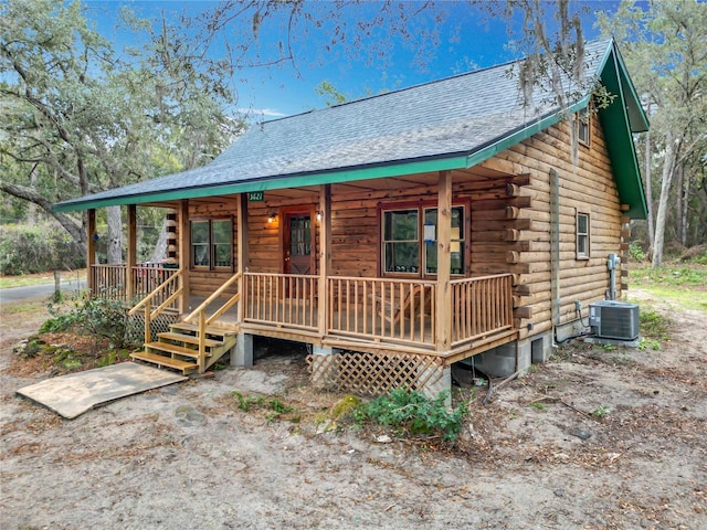 log home featuring a porch and central air condition unit