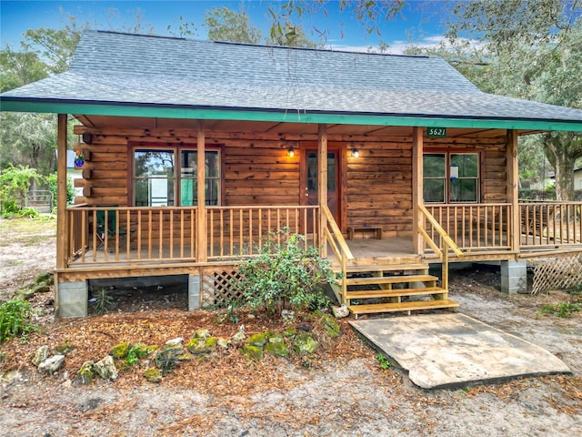 log cabin featuring a porch