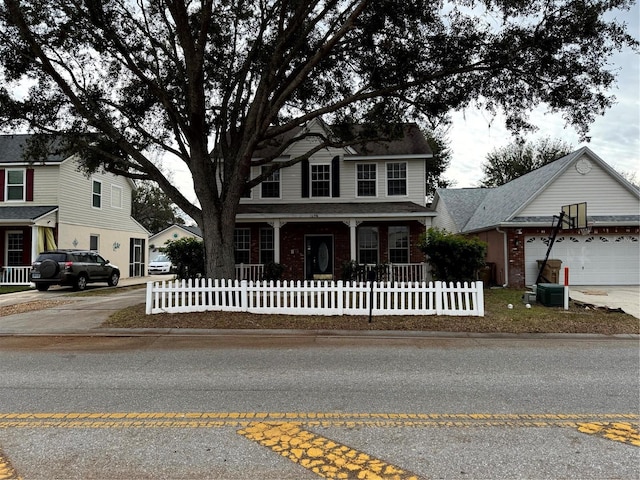 view of front of property featuring central AC unit and a garage