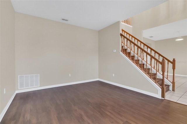 unfurnished room with wood-type flooring