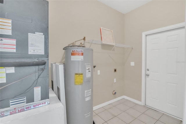 laundry area featuring electric dryer hookup, water heater, heating unit, and light tile patterned flooring