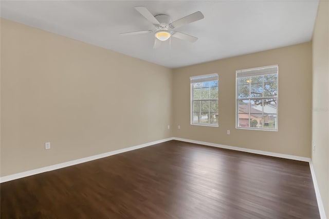 empty room featuring ceiling fan and dark wood-type flooring