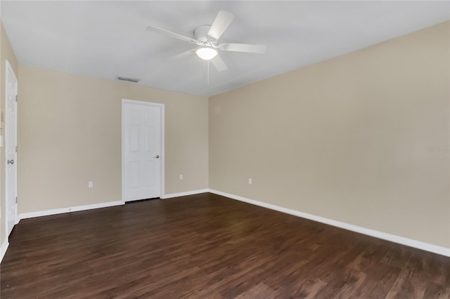 unfurnished room featuring dark wood-type flooring and ceiling fan