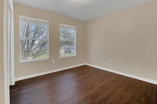 unfurnished room featuring dark hardwood / wood-style floors