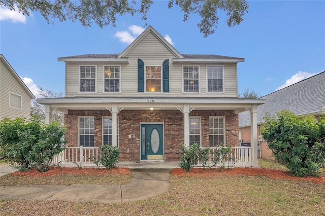 view of front of home featuring covered porch and a front yard