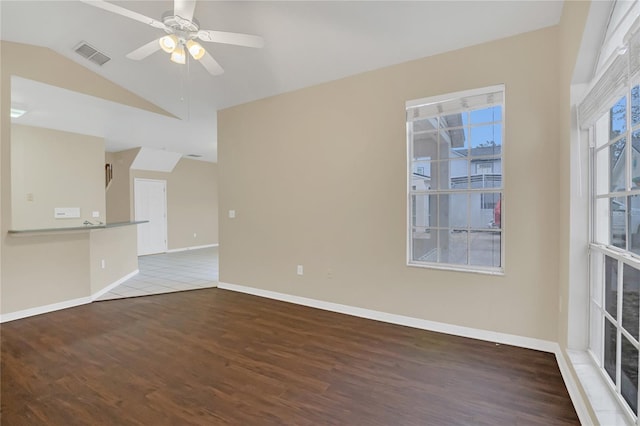 spare room with hardwood / wood-style flooring, lofted ceiling, and ceiling fan