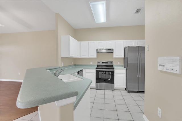 kitchen with sink, stainless steel appliances, kitchen peninsula, and light tile patterned floors