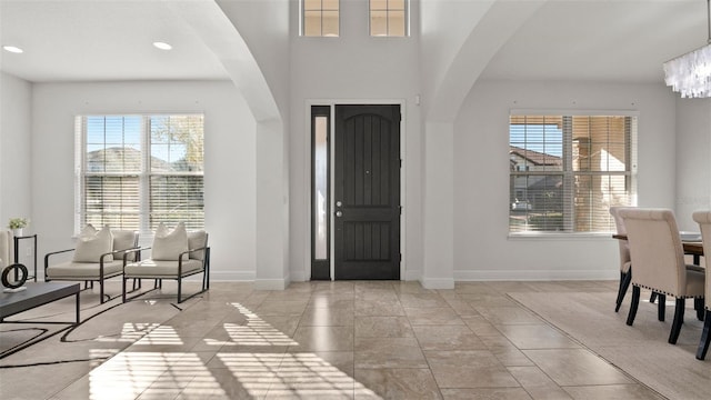 entryway featuring an inviting chandelier and light tile patterned floors