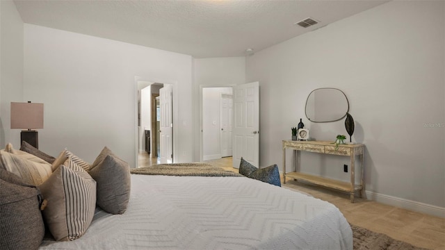 carpeted bedroom with a textured ceiling