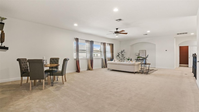 living room featuring light carpet and ceiling fan