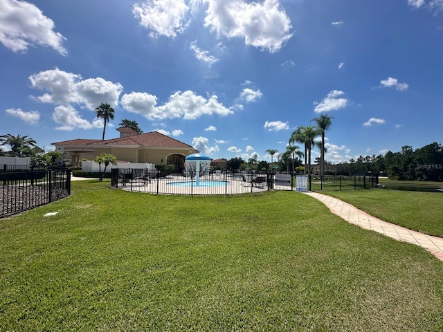 view of community with a swimming pool, a lawn, and a patio