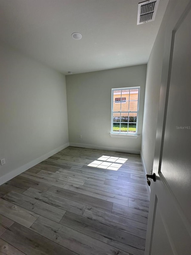 spare room with light hardwood / wood-style floors