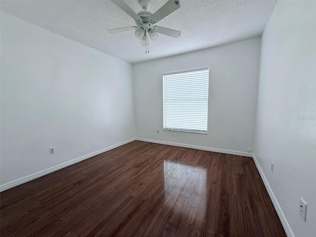 spare room with a textured ceiling, ceiling fan, and dark hardwood / wood-style floors