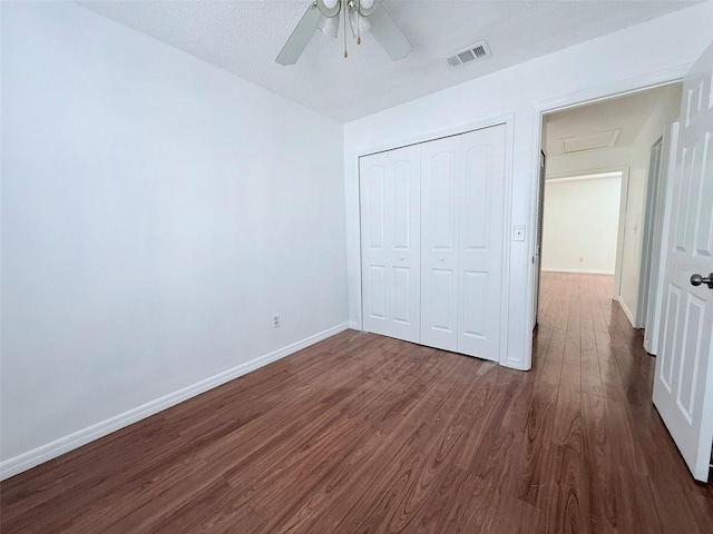 unfurnished bedroom featuring ceiling fan, a closet, and dark hardwood / wood-style floors