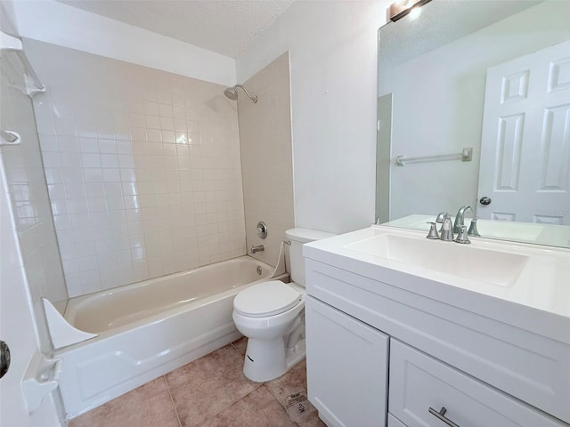 full bathroom featuring toilet, tiled shower / bath, tile patterned flooring, a textured ceiling, and vanity