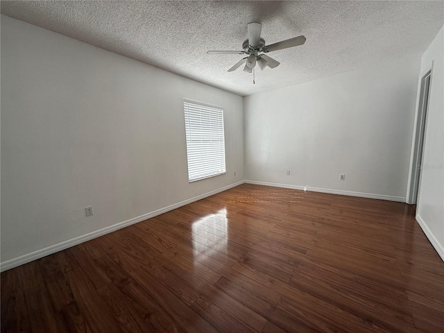 unfurnished room featuring ceiling fan, dark wood-type flooring, and a textured ceiling