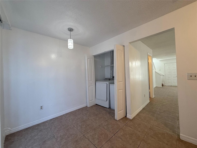 interior space with a textured ceiling and tile patterned flooring