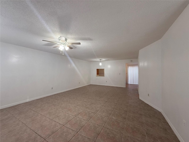 unfurnished room featuring ceiling fan, a textured ceiling, and light tile patterned flooring