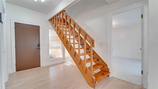 foyer entrance with a textured ceiling