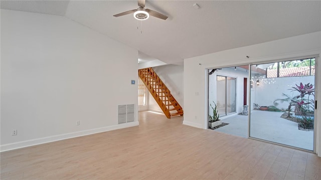 spare room featuring ceiling fan, vaulted ceiling, and light wood-type flooring