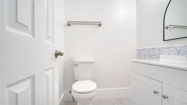 bathroom featuring toilet and vanity