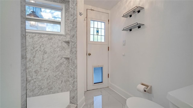 bathroom featuring toilet and walk in shower