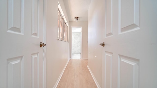 corridor with light wood-type flooring