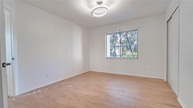 unfurnished bedroom featuring light hardwood / wood-style floors and a textured ceiling