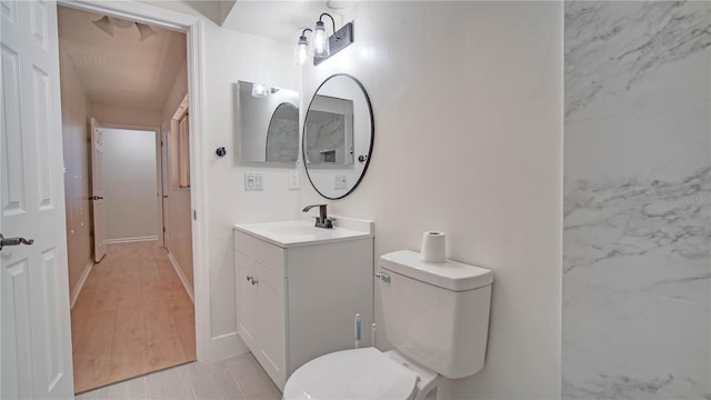 bathroom featuring toilet and vanity