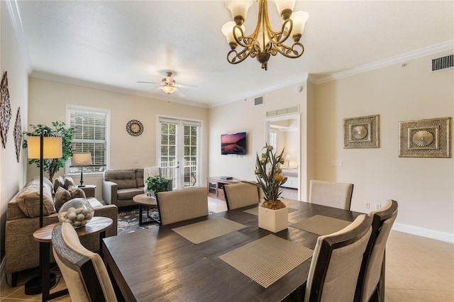 dining room featuring tile patterned floors, crown molding, ceiling fan with notable chandelier, and french doors