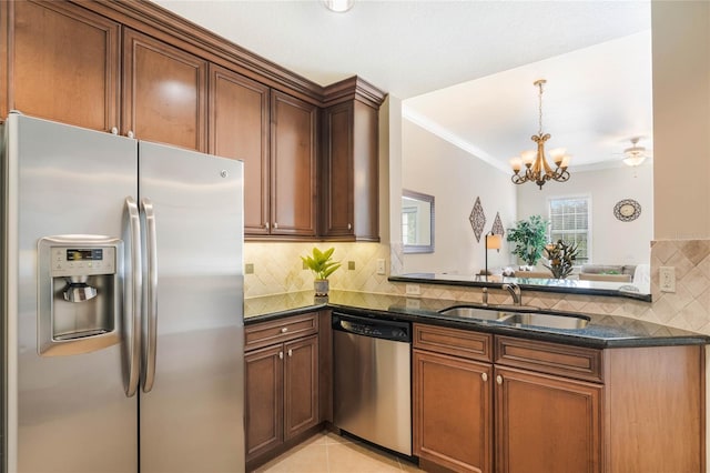 kitchen featuring dark stone countertops, sink, stainless steel appliances, light tile patterned floors, and ceiling fan with notable chandelier