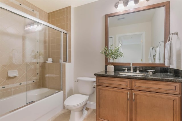 full bathroom featuring toilet, tile patterned flooring, vanity, and shower / bath combination with glass door