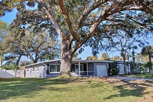 ranch-style home with a front yard and a garage