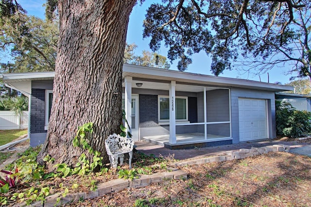 ranch-style house featuring covered porch and a garage