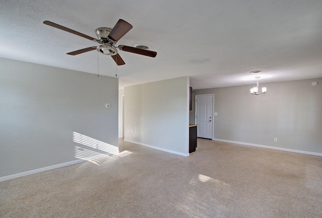 unfurnished room with ceiling fan with notable chandelier