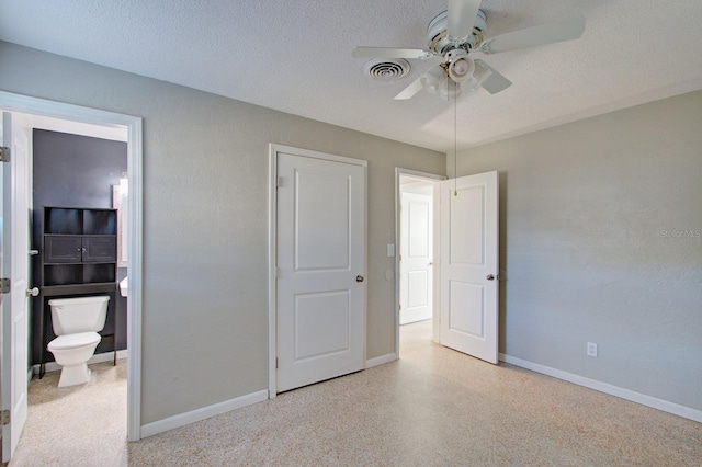 unfurnished bedroom featuring ensuite bathroom, ceiling fan, and a textured ceiling