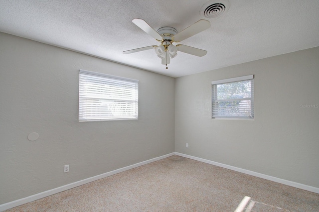 empty room featuring ceiling fan and a textured ceiling